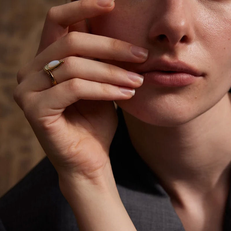 model wearing the Gold ring with white mother-of-pearl teardrop stones Amara Gemstone Ring by Montipi.