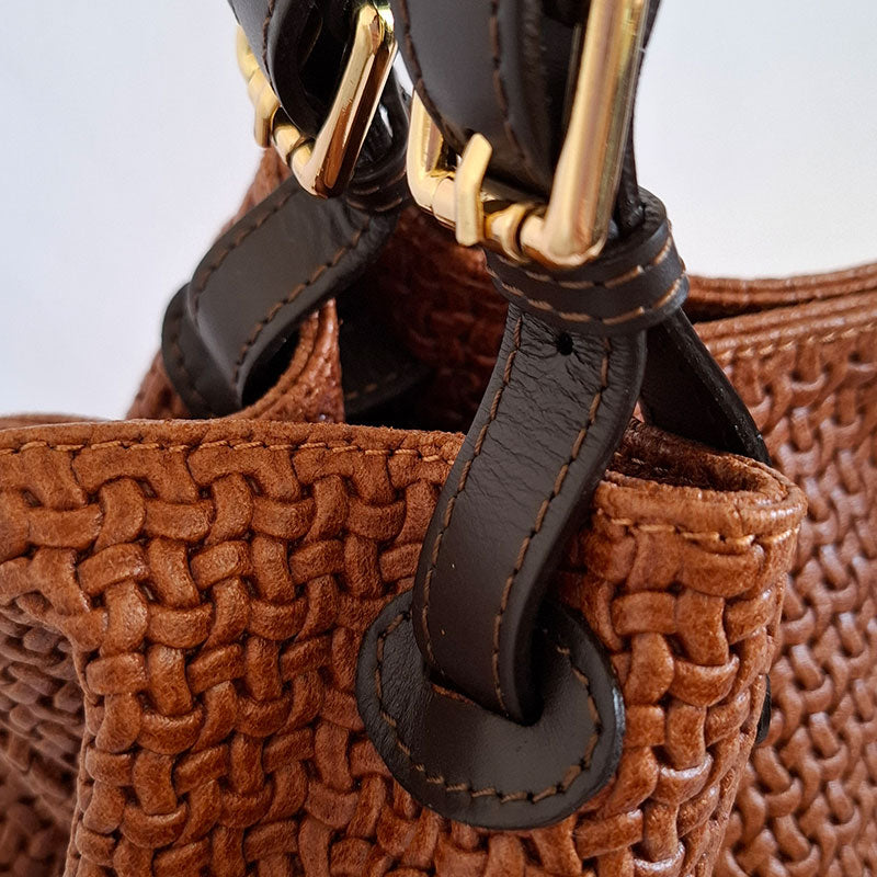 Close up of the Elegant and Luxurious leather details of the woven Leather gold tone hardware and leather handle details of the TL Keyluck Tote Bag in cognac leather by Montipi Australia a luxurious designer bag handcrafted with premium italian leather