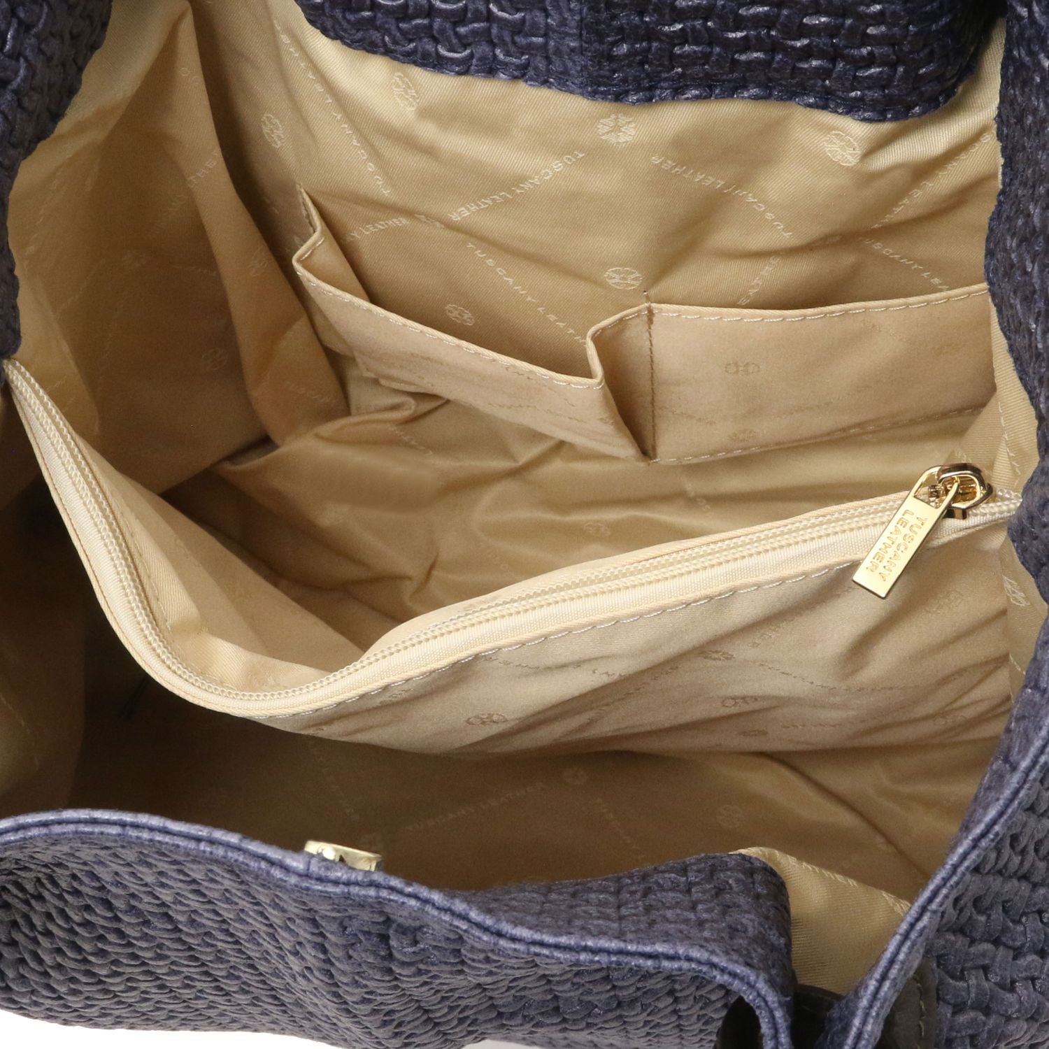 Close up of the Luxurious beige interior with large organised compartment with central internal zipped pocket and side pockets of the TL Keyluck Tote Bag in dark blue leather by Montipi Australia smart and convenient design to organise and quickly access all your essentials with luxurious beige fabric signature of premium designer bag