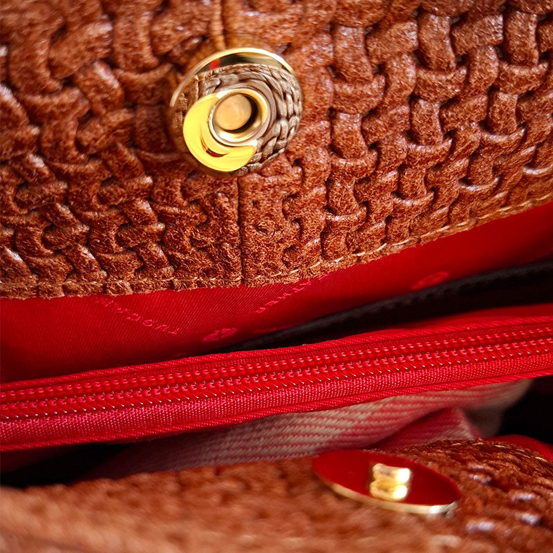 Close up of the Luxurious interior design of the TL Keyluck Tote Bag in cognac leather by Montipi Australia with luxurious gold tone hardware magnetic closure red interior with zipped pocket signature of premium designer bag