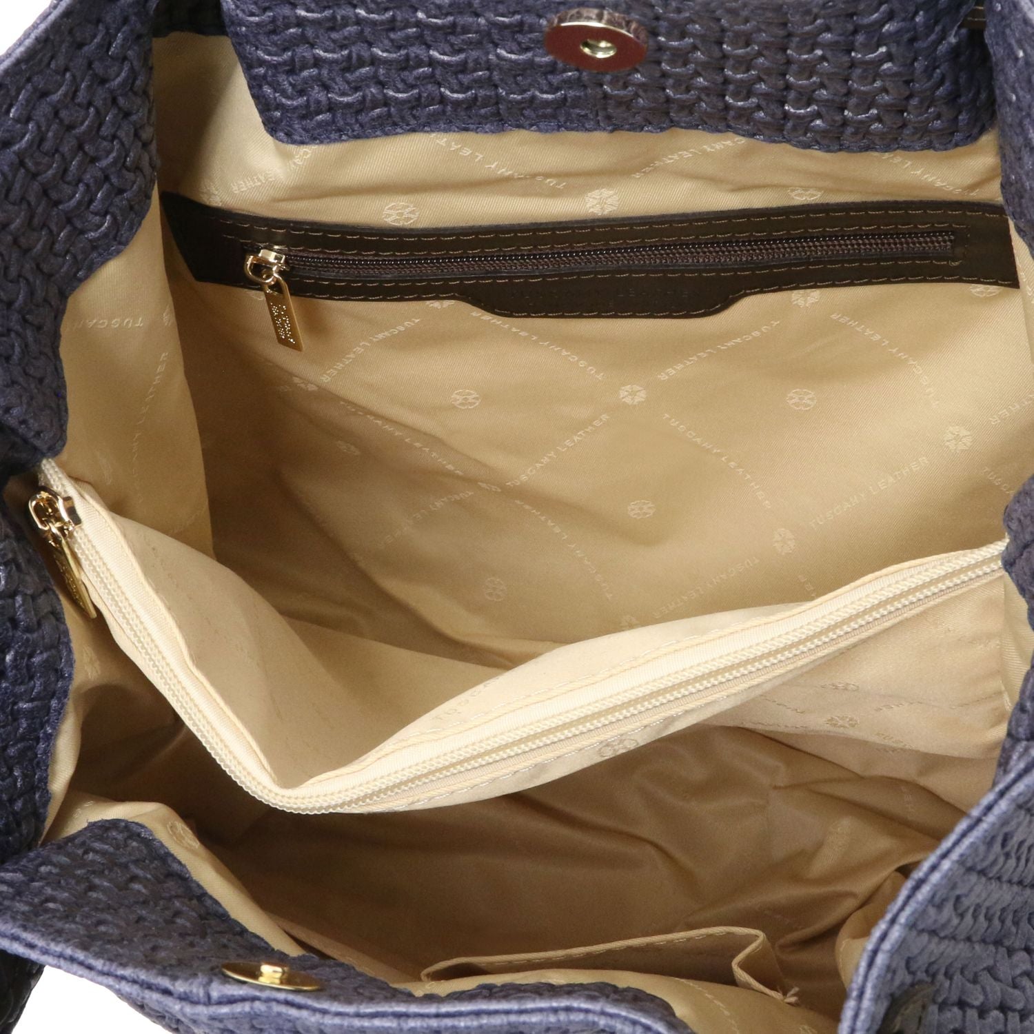 Close up of the Luxurious large organised compartment with beige interior and multiple internal zipped pockets and side pockets of the TL Keyluck Tote Bag in dark blue leather by Montipi Australia versatile convenient and durable with luxurious beige fabric signature of premium designer bag