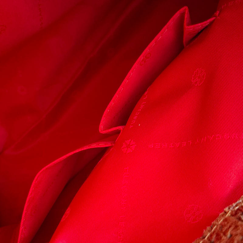 Close up of the Luxurious red interior design of the TL Keyluck Tote Bag in cognac leather by Montipi Australia with branded red interior and side pockets for mobile phone keys and everyday essentials in organised compartment signature of premium designer bag
