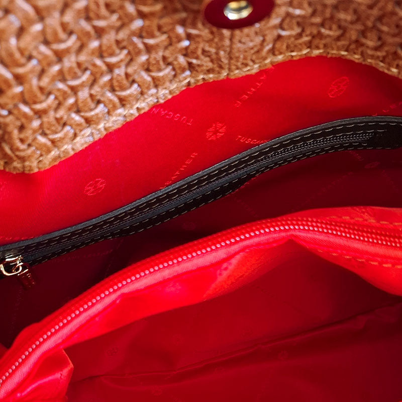 Close up of the Luxurious red interior design of the TL Keyluck Tote Bag in cognac leather by Montipi Australia with branded red interior with side zipped pocket and central zipped pocket signature of premium designer bag
