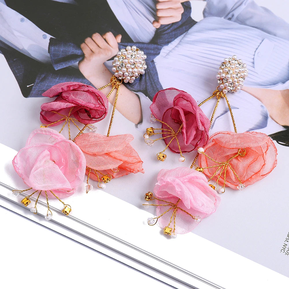 Pink floral hairpins with gold accents on a magazine background
