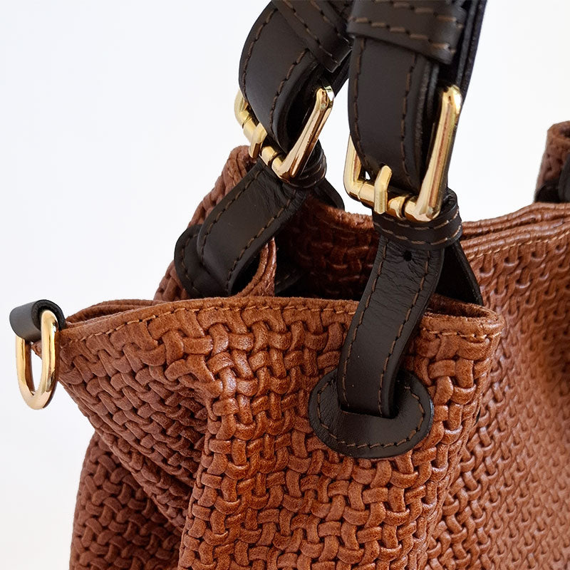 Elegant and Luxurious leather details of the woven Leather gold tone hardware and leather handle details of the TL Keyluck Tote Bag in cognac leather by Montipi Australia a luxurious designer bag handcrafted with premium italian leather