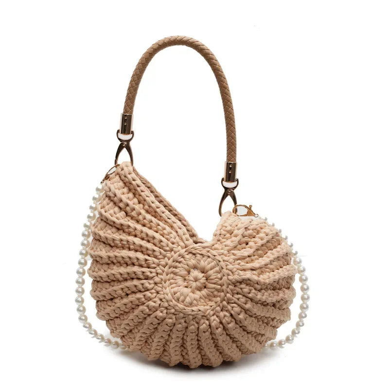 Fossil Seashell Bag in light brown soft woven cotton with shell shape by Montipi, styled in earthy beach tones – perfect for boho luxe, coastal chic, and summer outfits.