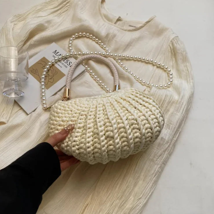 Fossil Seashell Bag in beige cream white  soft woven cotton with shell shape by Montipi, styled in earthy beach tones – perfect for boho luxe, coastal chic, and summer outfits.