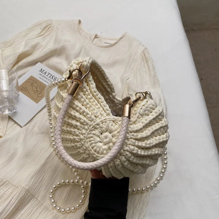 Fossil Seashell Bag in beige cream white  soft woven cotton with shell shape by Montipi, styled in earthy beach tones – perfect for boho luxe, coastal chic, and summer outfits.