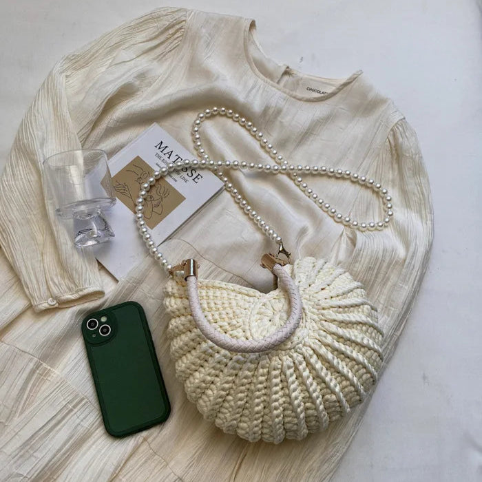 Fossil Seashell Bag in beige cream white  soft woven cotton with shell shape by Montipi, styled in earthy beach tones – perfect for boho luxe, coastal chic, and summer outfits.