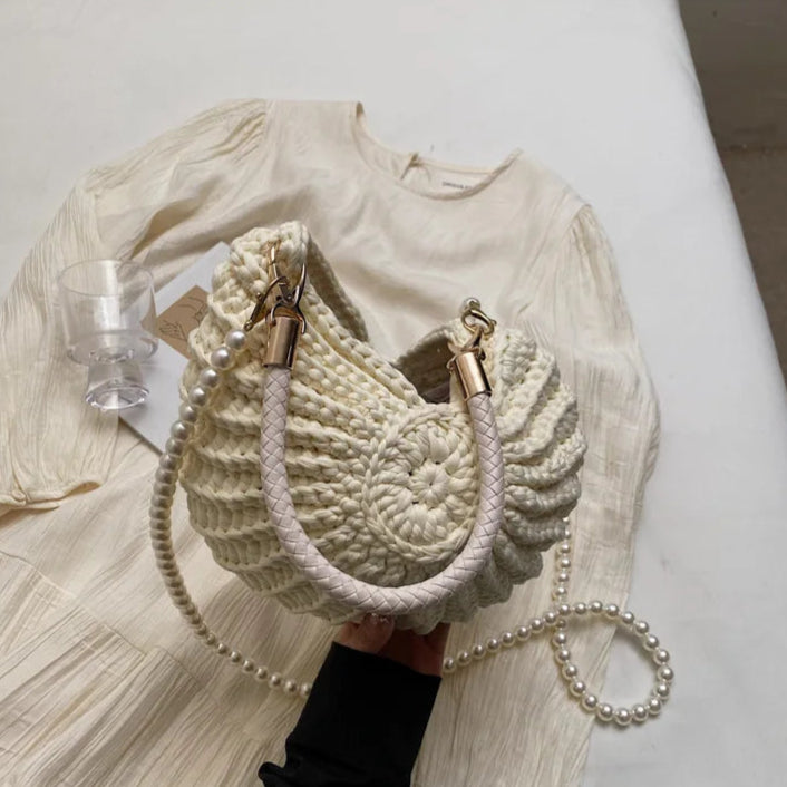 Fossil Seashell Bag in beige cream white  soft woven cotton with shell shape by Montipi, styled in earthy beach tones – perfect for boho luxe, coastal chic, and summer outfits.