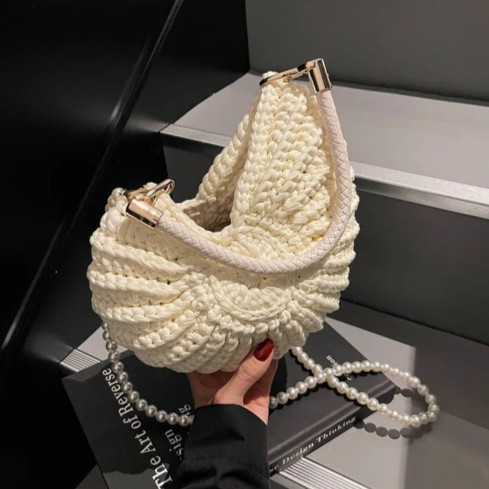 Fossil Seashell Bag in beige cream white  soft woven cotton with shell shape by Montipi, styled in earthy beach tones – perfect for boho luxe, coastal chic, and summer outfits.