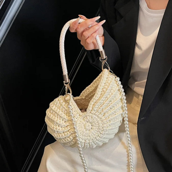 Fossil Seashell Bag in beige cream white  soft woven cotton with shell shape by Montipi, styled in earthy beach tones – perfect for boho luxe, coastal chic, and summer outfits.