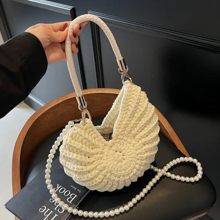 Fossil Seashell Bag in beige cream white  soft woven cotton with shell shape by Montipi, styled in earthy beach tones – perfect for boho luxe, coastal chic, and summer outfits.