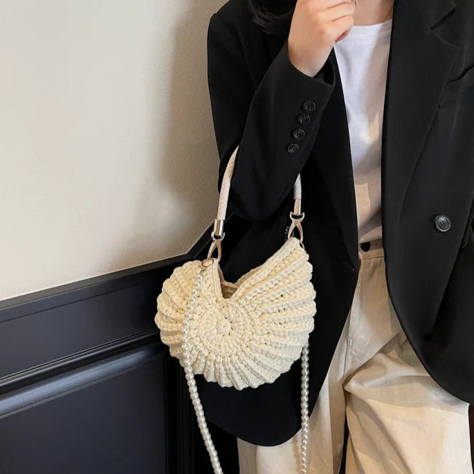 Fossil Seashell Bag in beige cream white  soft woven cotton with shell shape by Montipi, styled in earthy beach tones – perfect for boho luxe, coastal chic, and summer outfits.