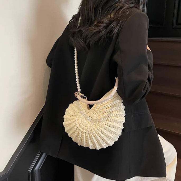 Fossil Seashell Bag in beige cream white  soft woven cotton with shell shape by Montipi, styled in earthy beach tones – perfect for boho luxe, coastal chic, and summer outfits.