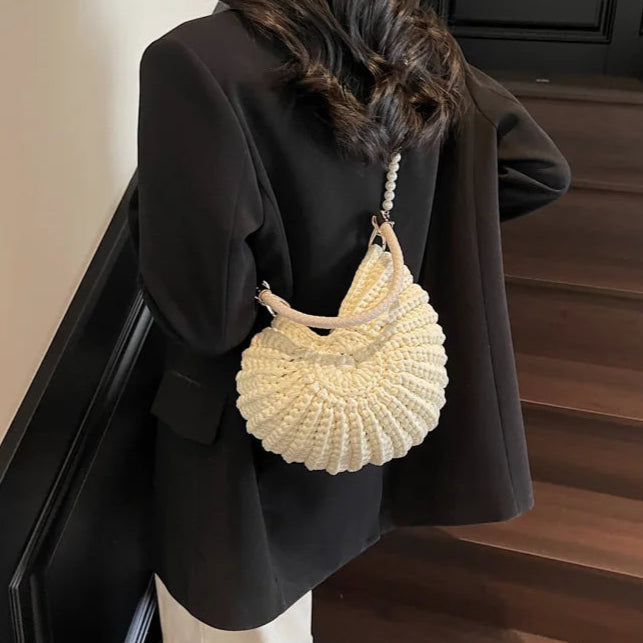 Fossil Seashell Bag in beige cream white  soft woven cotton with shell shape by Montipi, styled in earthy beach tones – perfect for boho luxe, coastal chic, and summer outfits.