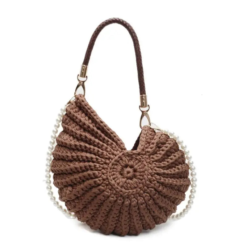 Fossil Seashell Bag in coffee brown soft woven cotton with shell shape by Montipi, styled in earthy beach tones – perfect for boho luxe, coastal chic, and summer outfits.
