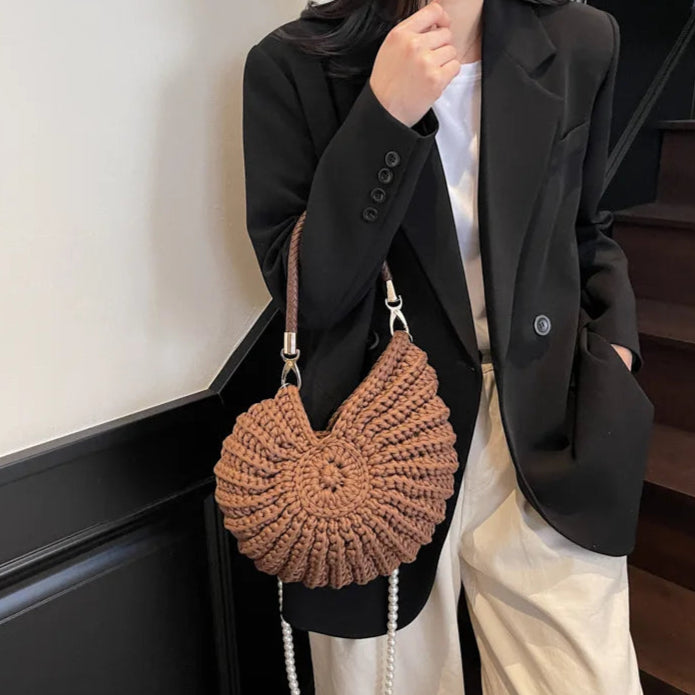 Fossil Seashell Bag in coffee brown soft woven cotton with shell shape by Montipi, styled in earthy beach tones – perfect for boho luxe, coastal chic, and summer outfits.