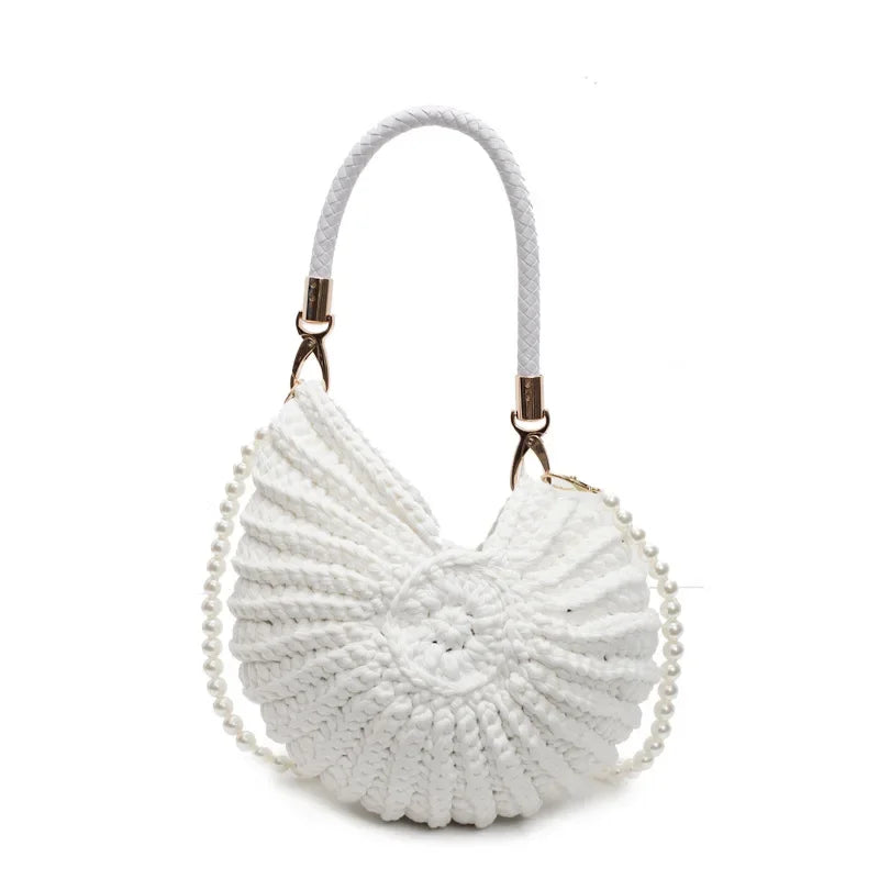 Fossil Seashell Bag in white soft woven cotton with shell shape by Montipi, styled in earthy beach tones – perfect for boho luxe, coastal chic, and summer outfits.