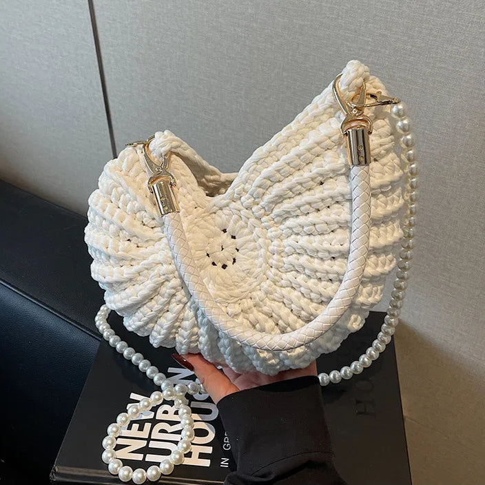 Fossil Seashell Bag in white soft woven cotton with shell shape by Montipi, styled in earthy beach tones – perfect for boho luxe, coastal chic, and summer outfits.