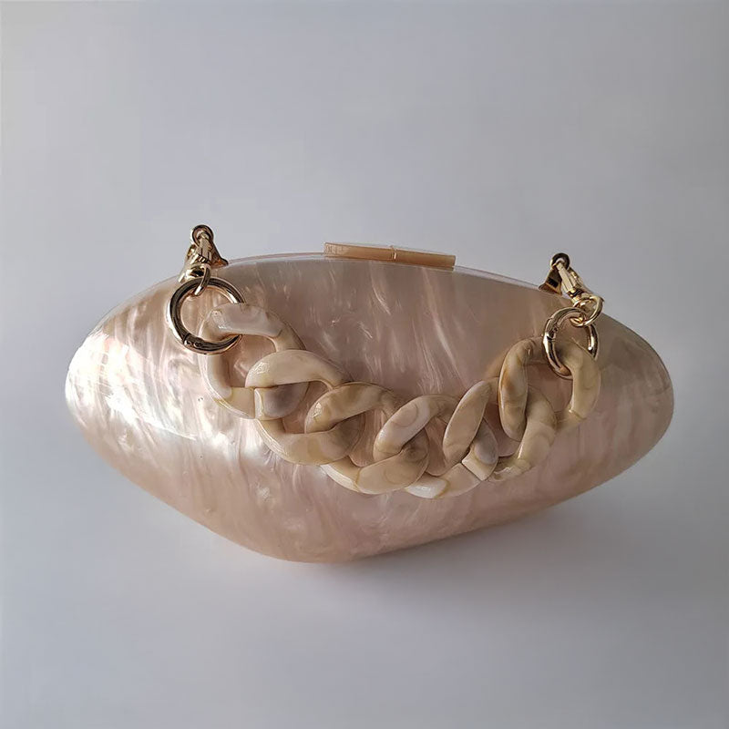 Beige Pearl Shell Clutch with Acrylic Chain Handle – A stylish acrylic clutch in a shimmering beige pearl finish, designed in a realistic seashell shape with a chic acrylic chain handle for versatile carrying. Perfect for weddings, beach parties, and coastal-inspired events. By Montipi Australia.