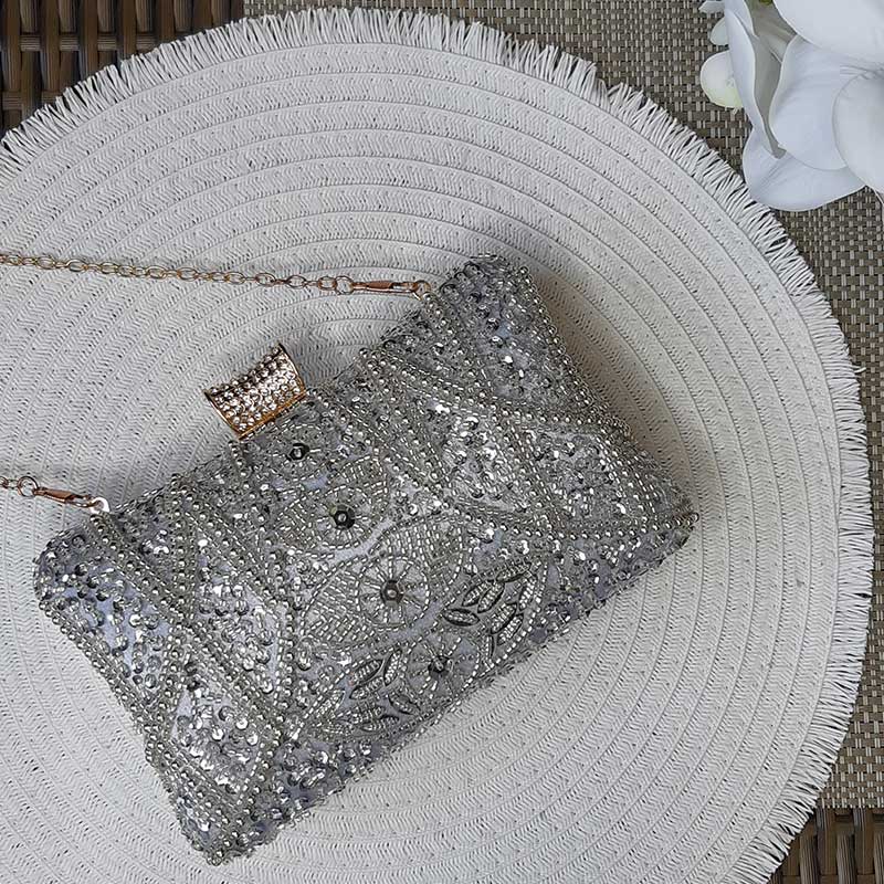 Luxe Silver Wedding Clutch Bag with intricate silver beaded design and silver sequin on elegant white background with white orchid perfect clutch for weddings by Montipi Australia