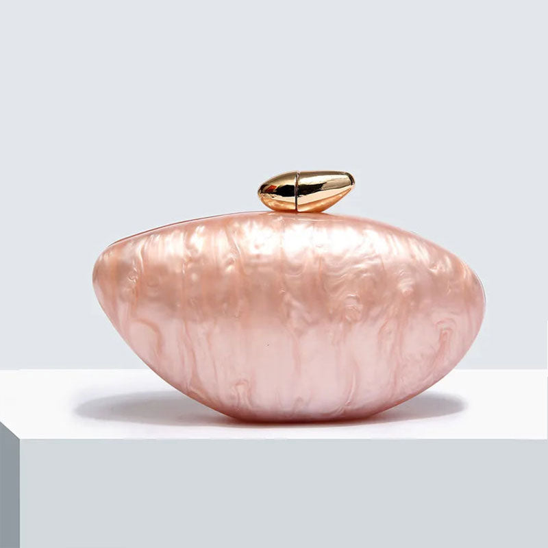 Soft pink seashell clutch bag with a dreamy pearl acrylic finish, gold hasp closure, and chain strap – perfect for weddings, soirées, and beachside style by Montipi Australia
