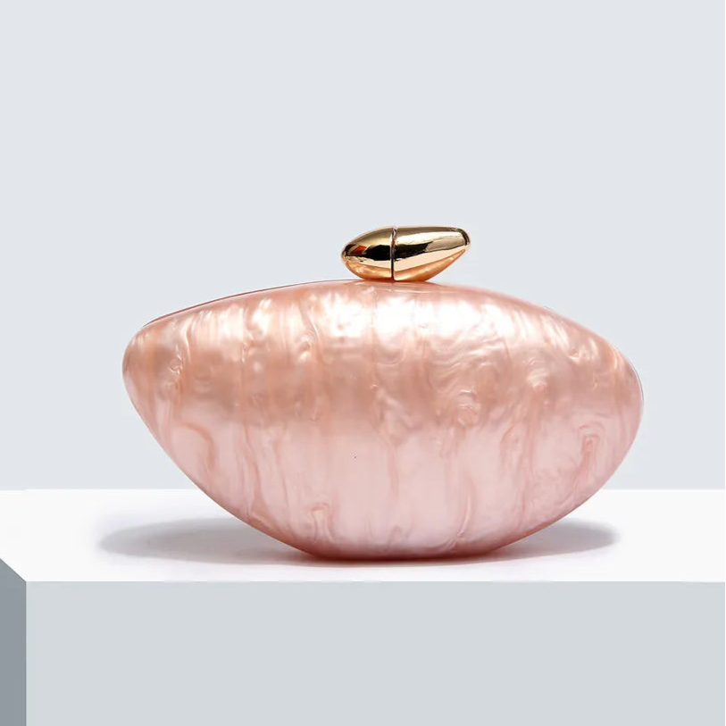 Soft pink seashell clutch bag with a dreamy pearl acrylic finish, gold hasp closure, and chain strap – perfect for weddings, soirées, and beachside style by Montipi Australia