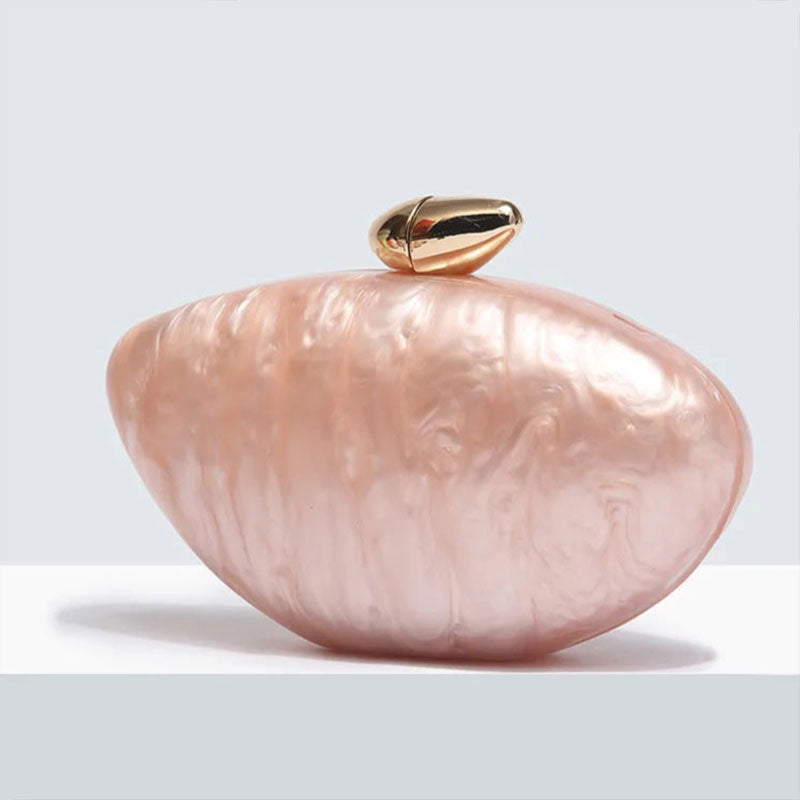 Soft pink seashell clutch bag with a dreamy pearl acrylic finish, gold hasp closure, and chain strap – perfect for weddings, soirées, and beachside style by Montipi Australia