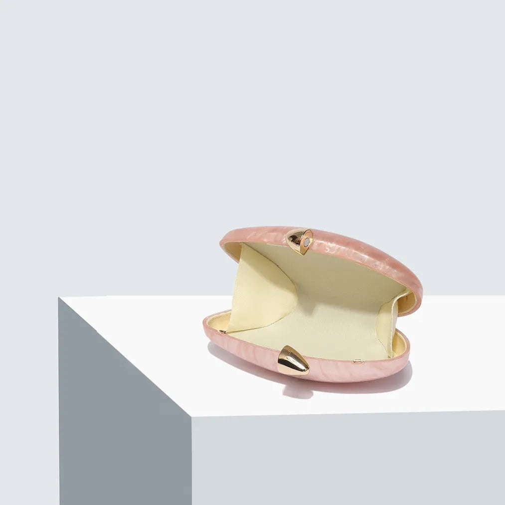 Soft pink seashell clutch bag with a dreamy pearl acrylic finish, gold hasp closure, and chain strap – perfect for weddings, soirées, and beachside style by Montipi Australia