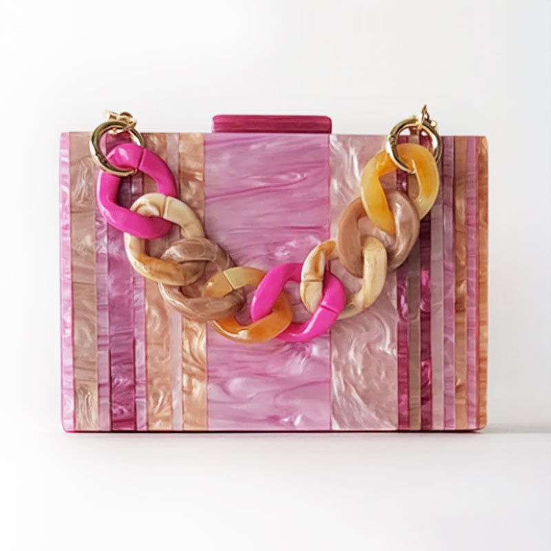 Pink Mirage Acrylic Clutch Bag featuring a striped pearl acrylic finish and colourful resin chain handle – perfect for weddings, resort chic, and boho luxe outfits.