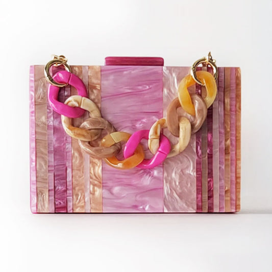Pink Mirage Acrylic Clutch Bag featuring a striped pearl acrylic finish and colourful resin chain handle – perfect for weddings, resort chic, and boho luxe outfits.