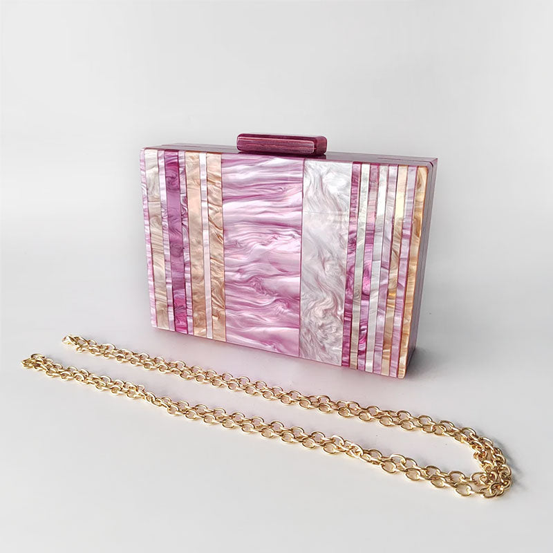 Pink Mirage Acrylic Clutch Bag featuring a striped pearl acrylic finish and colourful resin chain handle – perfect for weddings, resort chic, and boho luxe outfits.