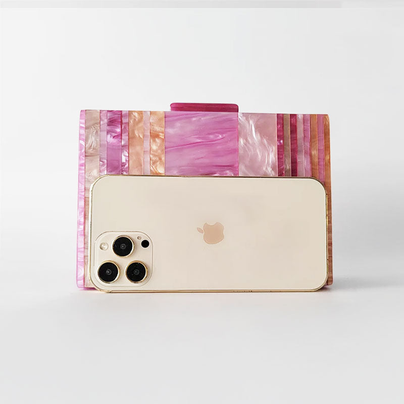 Pink Mirage Acrylic Clutch Bag featuring a striped pearl acrylic finish and colourful resin chain handle – perfect for weddings, resort chic, and boho luxe outfits.