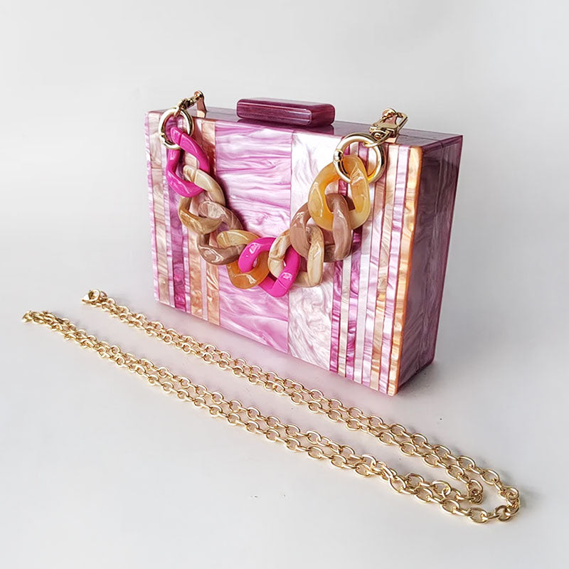 Pink Mirage Acrylic Clutch Bag featuring a striped pearl acrylic finish and colourful resin chain handle – perfect for weddings, resort chic, and boho luxe outfits.