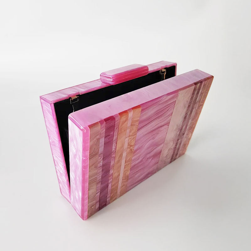 Pink Mirage Acrylic Clutch Bag featuring a striped pearl acrylic finish and colourful resin chain handle – perfect for weddings, resort chic, and boho luxe outfits.