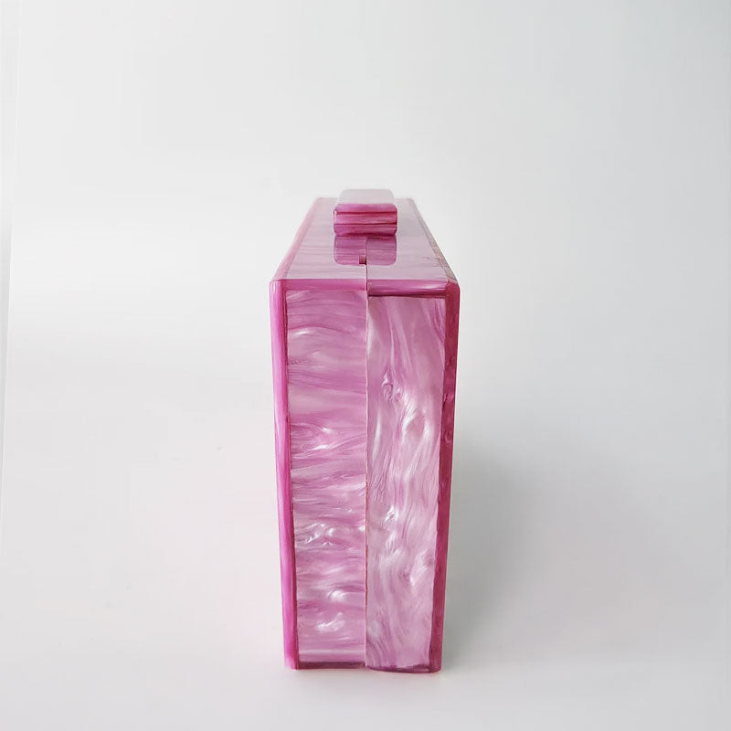 Pink Mirage Acrylic Clutch Bag featuring a striped pearl acrylic finish and colourful resin chain handle – perfect for weddings, resort chic, and boho luxe outfits.