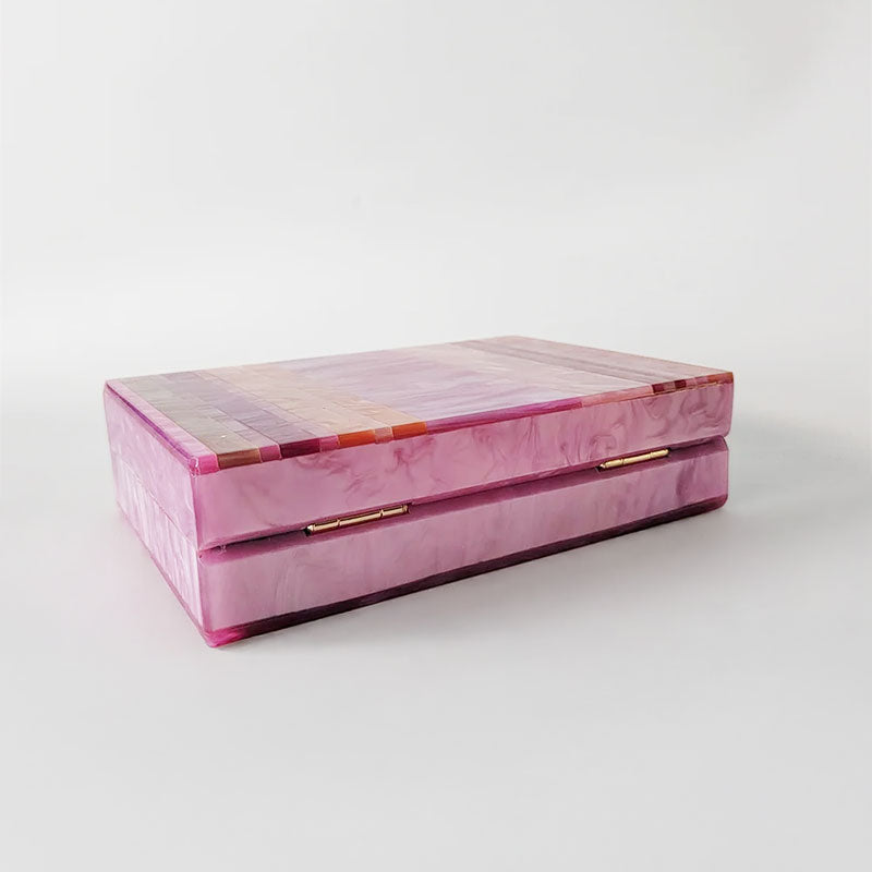 Pink Mirage Acrylic Clutch Bag featuring a striped pearl acrylic finish and colourful resin chain handle – perfect for weddings, resort chic, and boho luxe outfits.
