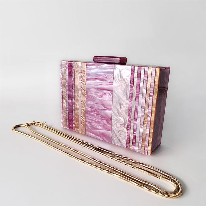 Pink Mirage Acrylic Clutch Bag featuring a striped pearl acrylic finish and colourful resin chain handle – perfect for weddings, resort chic, and boho luxe outfits.