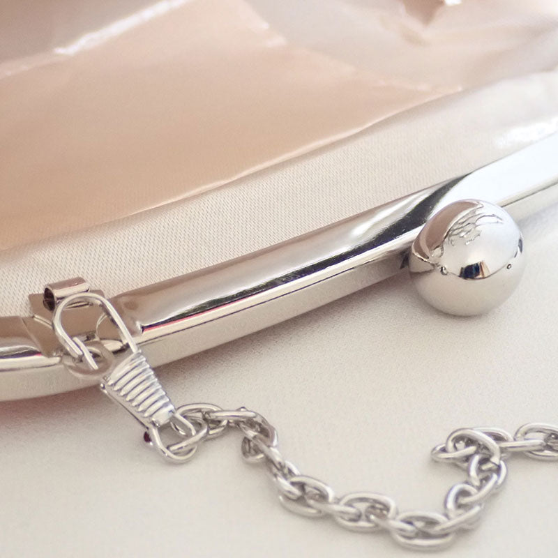 Close up of the Chain Strap and Hasp Closure Details in silver of the Rose Chic Petal Clutch Bag by Montipi Australia