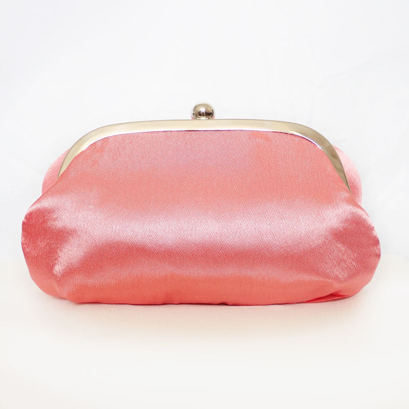 Back view of delicate rose-shaped clutch bag with layered petal detailing in a soft, romantic hue. The elegant floral design mimics the texture of blooming petals, creating a timeless statement piece. Set against a refined backdrop, the clutch exudes femininity and sophistication, perfect for weddings, cocktail events, and special occasions. Rose Chic Petal Clutch Bag in rose pink by Montipi Australia
