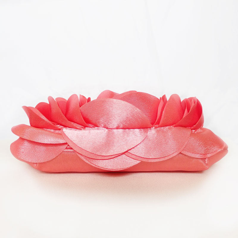Side front view of the Rose Chic Petal Clutch in a Couture pose. A delicate rose-shaped clutch bag with layered petal detailing in a soft, romantic hue. The elegant floral design mimics the texture of blooming petals, creating a timeless statement piece. Set against a refined backdrop, the clutch exudes femininity and sophistication, perfect for weddings, cocktail events, and special occasions. Rose Chic Petal Clutch Bag in rose pink by Montipi Australia