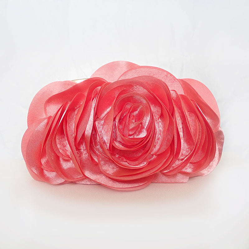 Front view of delicate rose-shaped clutch bag with layered petal detailing in a soft, romantic hue. The elegant floral design mimics the texture of blooming petals, creating a timeless statement piece. Set against a refined backdrop, the clutch exudes femininity and sophistication, perfect for weddings, cocktail events, and special occasions. Rose Chic Petal Clutch Bag in rose pink by Montipi Australia