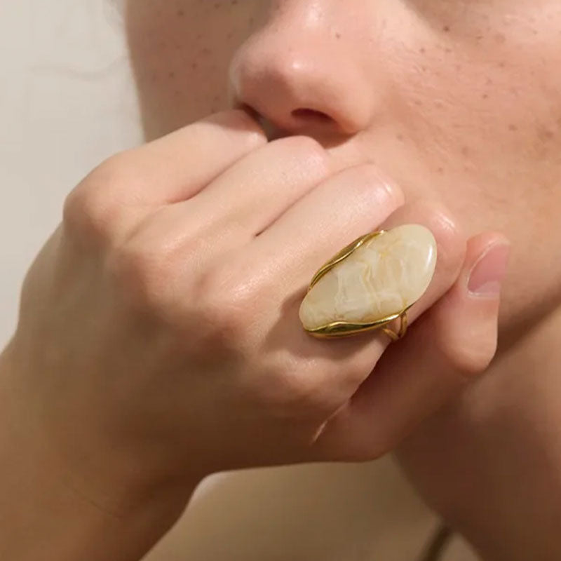Model close-up wearing Solara Gemstone Ring in Ivory – elegant statement piece