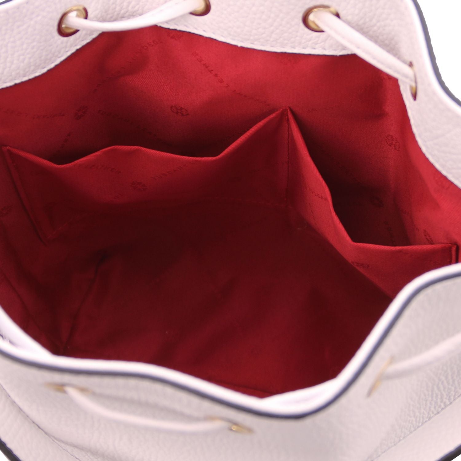 Interior view of the TL Leather Bucket Bag in white by Montipi Australia, showcasing the bold red lining, dual slide pockets, and spacious compartment for effortless organization. Crafted from premium Italian pebbled leather with gold-tone hardware, this elegant bucket bag combines sophistication with practicality