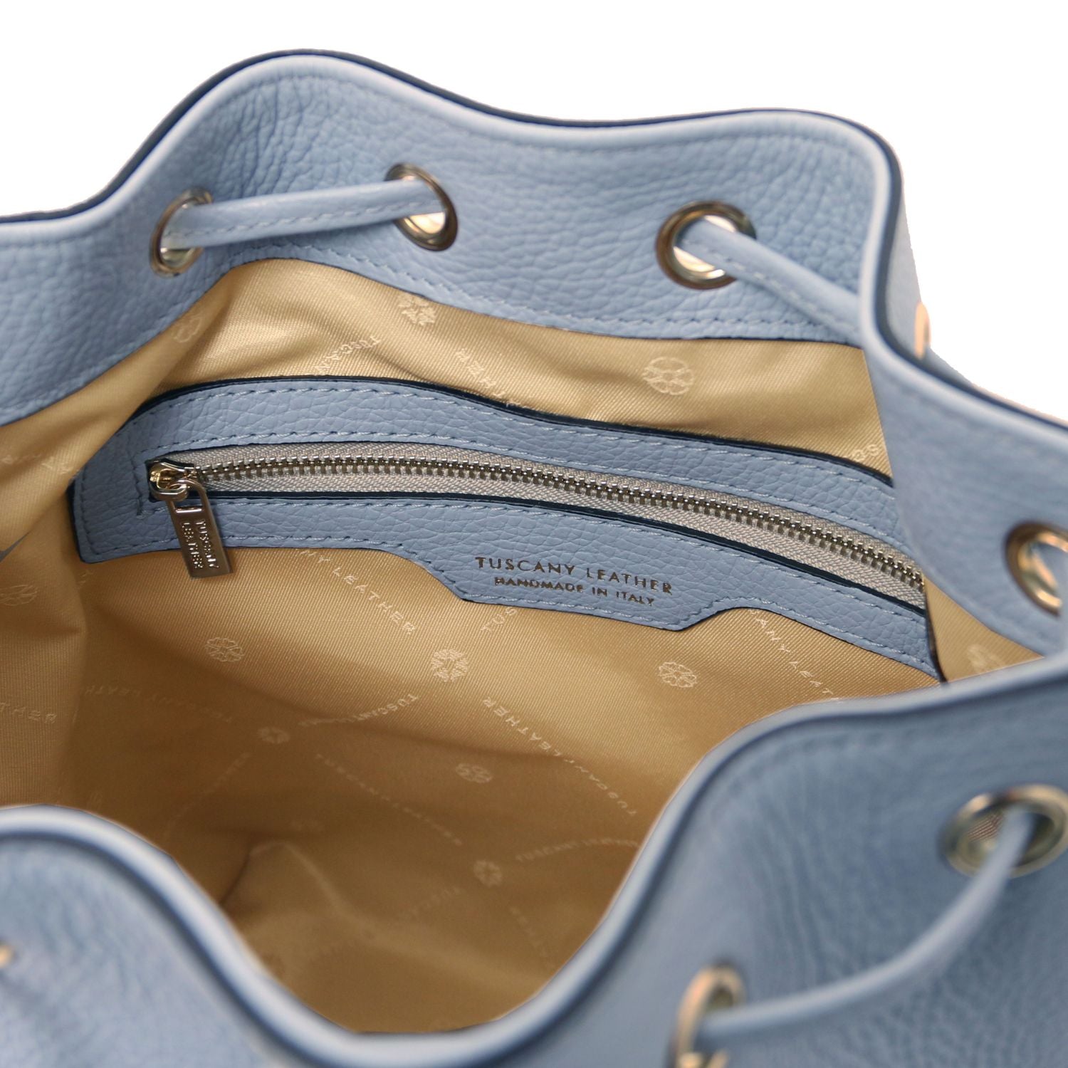 Interior view of the TL Leather Bucket Bag in light blue by Montipi Australia, featuring a bold red lining, spacious compartment, and secure internal zip pocket. Crafted from premium Italian pebbled leather with gold-tone hardware, this chic bucket bag blends elegance with everyday practicality.