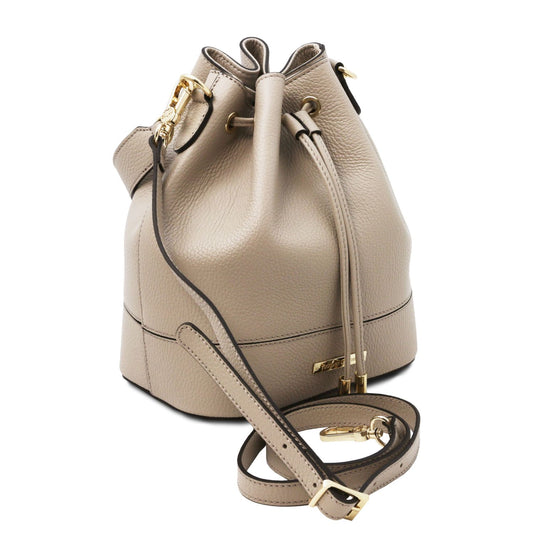 Angled view of the TL Leather Bucket Bag in beige light taupe by Montipi Australia, showcasing its premium Italian pebbled leather, structured silhouette, and elegant drawstring closure with gold-tone hardware. A versatile handbag with a detachable top handle and adjustable shoulder strap, designed for everyday sophistication and effortless style.