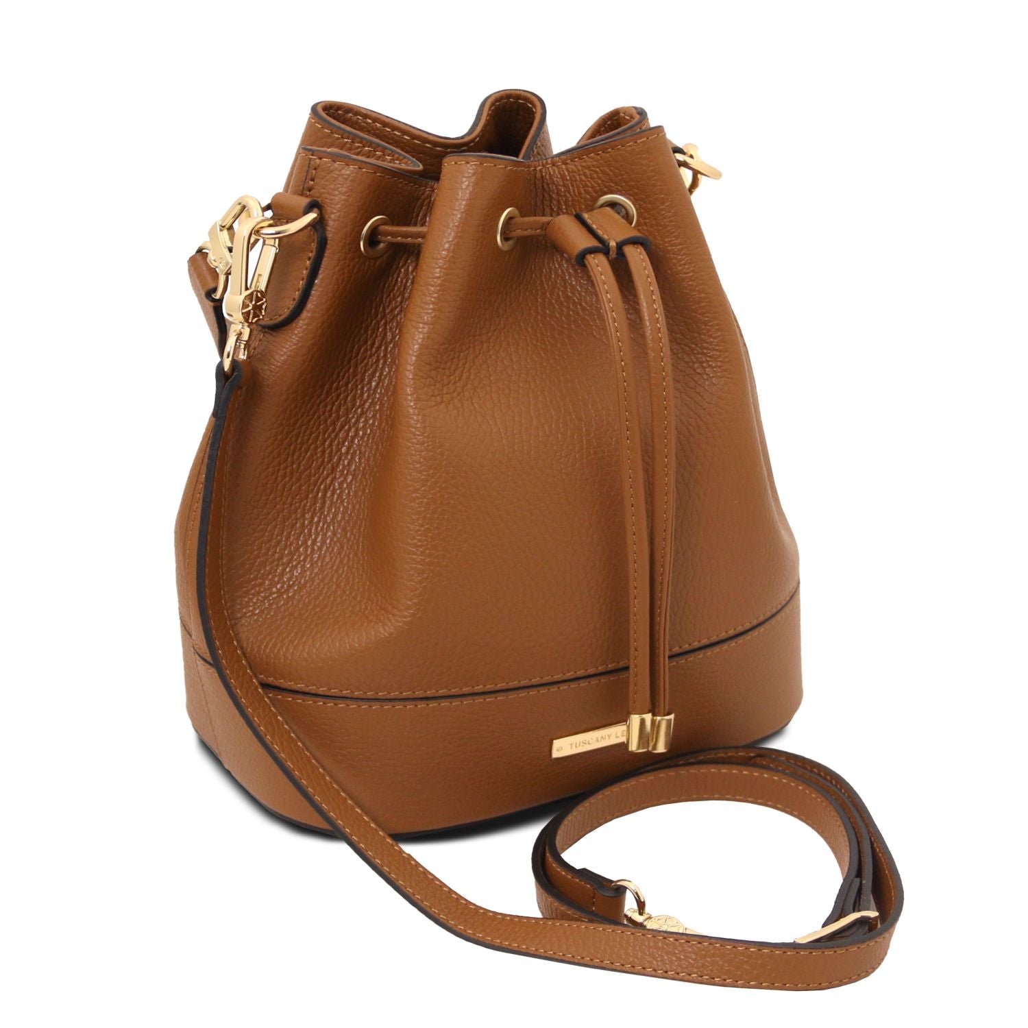 Angled view of the TL Leather Bucket Bag in cognac brown by Montipi Australia, showcasing its premium Italian pebbled leather, structured silhouette, and elegant drawstring closure with gold-tone hardware. A versatile handbag with a detachable top handle and adjustable shoulder strap, designed for everyday sophistication and effortless style.