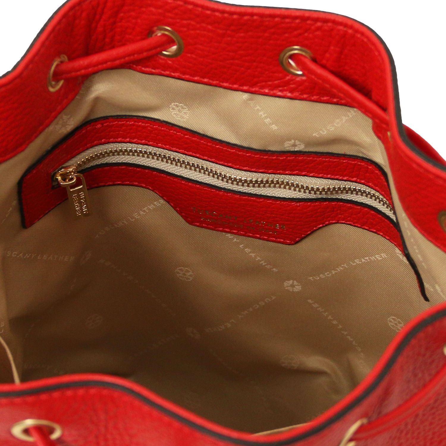 Interior view of the TL Leather Bucket Bag in red by Montipi Australia, featuring a beige lining, spacious compartment, and secure internal zip pocket. Crafted from premium Italian pebbled leather with gold-tone hardware, this chic bucket bag blends elegance with everyday practicality.