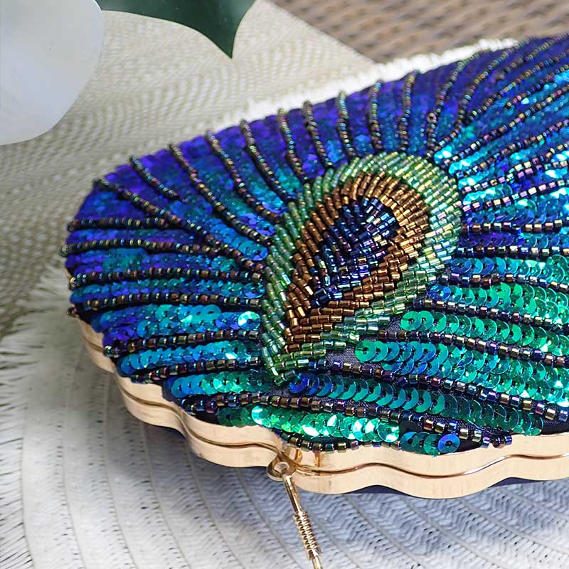 Close up on Teal Sequin Peacock Clutch with detailed beadwork design in feather shape, unique statement clutch bag elegant whimsical eclectic chic style by Montipi Australia